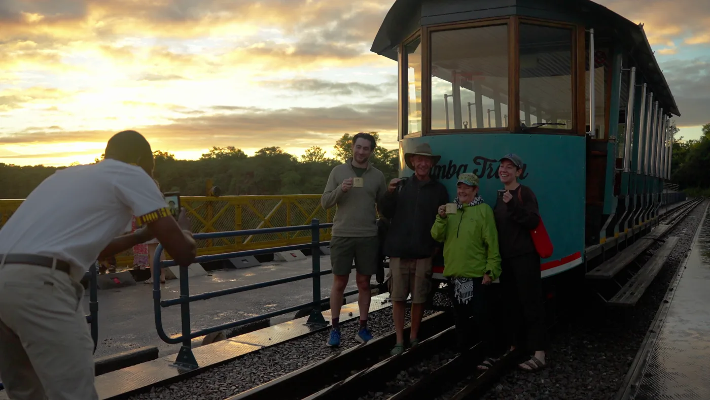 Guests with the Bamba Tram on the Victoria Falls Bridge at sunrise