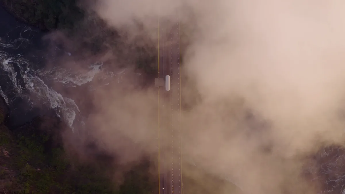 Aerial view of the Victoria Falls Bridge disappearing into the mist
